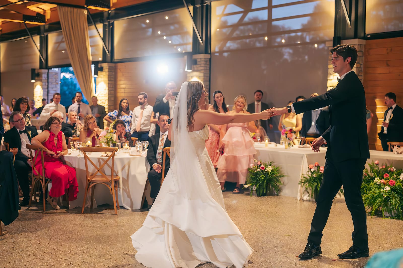 Carol and Eric holding hands during their first dance