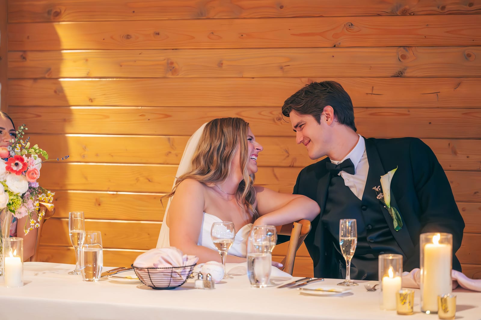 Carol and Eric laughing together at their reception table